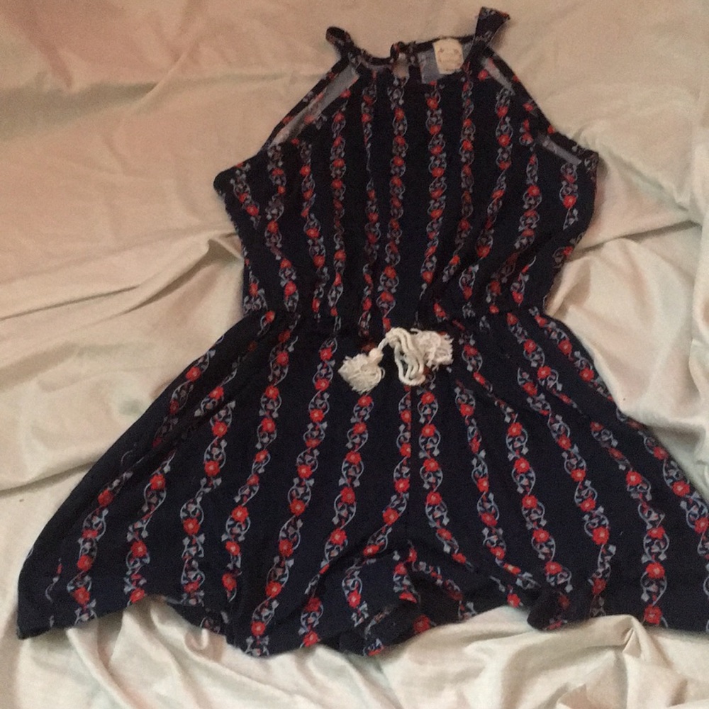 dark blue romper wit red flowers and a button back